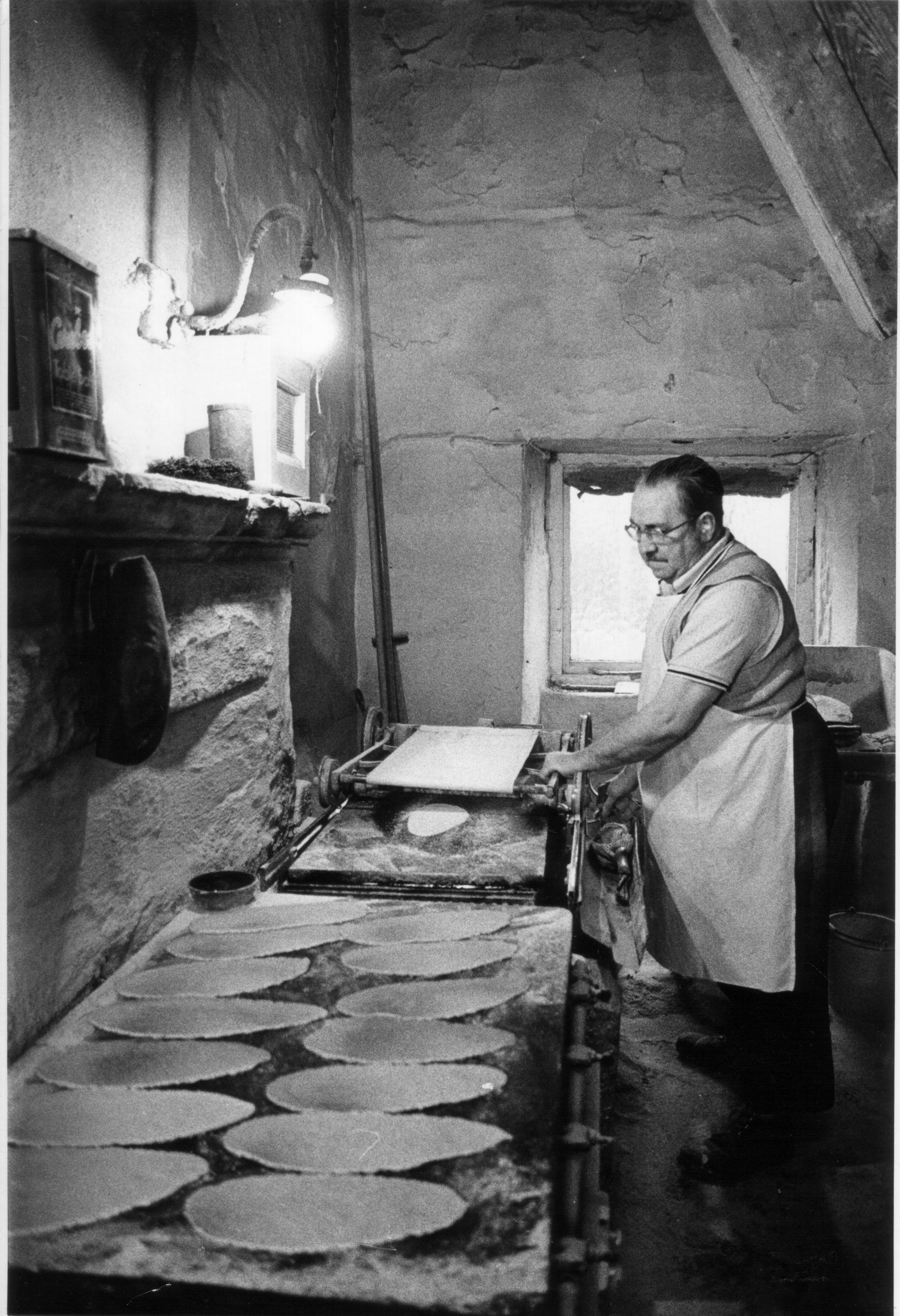 Alan making oatcakes early morning by gaslight, from the Family Archive